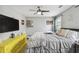 Bright bedroom with ceiling fan, TV, and a unique yellow dresser at 2704 W Main St, Tampa, FL 33607