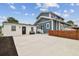 The home's exterior features a well-maintained yard and a detached structure at 2704 W Main St, Tampa, FL 33607