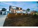 Charming two-story home exterior featuring a well-lit facade, fenced yard and inviting curb appeal at 2704 W Main St, Tampa, FL 33607