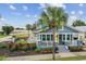 Charming two-story blue home with a welcoming front porch and a beautifully landscaped front yard and cozy backyard at 2704 W Main St, Tampa, FL 33607