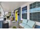 Inviting porch with cozy seating, a bright yellow door, and ample natural light creating a relaxing atmosphere at 2704 W Main St, Tampa, FL 33607