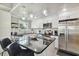 Bright kitchen with white cabinets, stainless steel appliances, granite countertops, and an island with bar seating at 2704 W Main St, Tampa, FL 33607