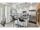 Updated kitchen features white cabinetry, stainless appliances, granite countertops, and bar seating at kitchen island at 2704 W Main St, Tampa, FL 33607