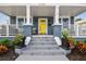 Back of house featuring outdoor seating and stairs leading to rear entry; the yard has a lovely firepit at 2704 W Main St, Tampa, FL 33607