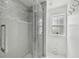 This upgraded shower features beautiful tile work, glass enclosure, and a shower head at 2704 W Main St, Tampa, FL 33607