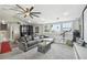 A large home theater space featuring a projector screen, cabinets, and a gray sectional couch at 2704 W Main St, Tampa, FL 33607