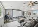 Spacious home theater features a projector screen, telescope, and gray sectional couch at 2704 W Main St, Tampa, FL 33607