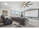 A home theater room boasts a projector screen, plush seating, and a large fan at 2704 W Main St, Tampa, FL 33607