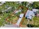 Aerial view of the property with mature trees, lush landscaping, and a long driveway to the carport at 2909 60Th N Ave, St Petersburg, FL 33714