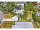 Aerial view of the property with mature landscaping, carport, backyard fire pit, and privacy fence at 2909 60Th N Ave, St Petersburg, FL 33714