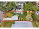 Aerial view of the property with mature landscaping, carport, backyard fire pit, and privacy fence at 2909 60Th N Ave, St Petersburg, FL 33714