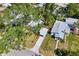Aerial view of the property with mature trees, lush landscaping, and a long driveway to the carport at 2909 60Th N Ave, St Petersburg, FL 33714