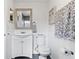 Bright bathroom features a decorative mirror, modern vanity, toilet, and wall-mounted towel and toilet paper holders at 2909 60Th N Ave, St Petersburg, FL 33714