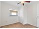 Spare bedroom features a ceiling fan, a large window, and a sizable closet for ample storage space at 2909 60Th N Ave, St Petersburg, FL 33714