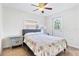 Cozy bedroom offers a ceiling fan, large windows, closet, and a comfortable bed with floral-patterned bedding at 2909 60Th N Ave, St Petersburg, FL 33714