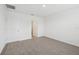 A carpeted bedroom featuring a neutral color palette, door to the bathroom, and a closet at 3590 Moscato Dr, Brooksville, FL 34602