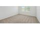 A bright, carpeted bedroom with large window providing plenty of natural light at 3590 Moscato Dr, Brooksville, FL 34602