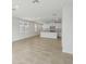 Open-concept kitchen featuring white cabinetry, stainless appliances, granite counters and a tile floor at 3590 Moscato Dr, Brooksville, FL 34602