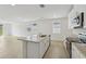Kitchen island with stainless steel sink and granite countertops, overlooking the living area at 3590 Moscato Dr, Brooksville, FL 34602