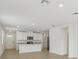 Bright kitchen with white cabinets, stainless steel appliances, granite countertops, and an island at 3590 Moscato Dr, Brooksville, FL 34602