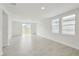 Living room with tile flooring and windows, offering natural light and a view of the outdoors at 3590 Moscato Dr, Brooksville, FL 34602