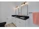 Modern bathroom featuring double vanity with black countertop and sleek fixtures and a black toilet at 4021 Ohio Ave, Tampa, FL 33616