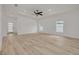 Bright bedroom featuring fresh paint, two windows, and vinyl flooring at 4021 Ohio Ave, Tampa, FL 33616