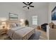 Staged bedroom displays neutral decor, with decorative art, furniture, and ample natural light at 4021 Ohio Ave, Tampa, FL 33616