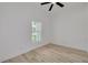 Bright, empty bedroom with a ceiling fan, modern flooring, and a window at 4021 Ohio Ave, Tampa, FL 33616