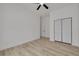 Spacious bedroom with light-colored floors, featuring a closet for extra storage and a ceiling fan at 4021 Ohio Ave, Tampa, FL 33616