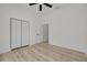 Bright bedroom with light wood floors, ceiling fan, closet and ensuite bathroom access at 4021 Ohio Ave, Tampa, FL 33616