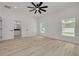 Bright bedroom featuring modern flooring, bathroom access, and natural light through windows at 4021 Ohio Ave, Tampa, FL 33616
