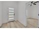 Bright foyer with a modern front door leading into a room with sleek flooring and a ceiling fan at 4021 Ohio Ave, Tampa, FL 33616