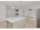 Open kitchen area with a large center island, stainless steel appliances, and seamless flow to the living area at 4021 Ohio Ave, Tampa, FL 33616