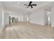 An open-concept living room with kitchen view, light wood floors, and tray ceilings at 4021 Ohio Ave, Tampa, FL 33616