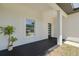 Inviting front porch with a modern front door, fresh paint, and a view of the neighborhood at 4021 Ohio Ave, Tampa, FL 33616