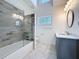 Bathroom features tiled shower with glass door, vanity, and tiled flooring at 404 Hillsborough St, Palm Harbor, FL 34683