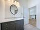 Bathroom features a vanity with stone countertop, modern mirror, and tiled flooring at 404 Hillsborough St, Palm Harbor, FL 34683