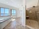Bathroom featuring a large soaking tub, tiled shower, and waterfront views at 404 Hillsborough St, Palm Harbor, FL 34683