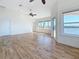 Spacious bedroom featuring hardwood floors, ceiling fans, and ample windows at 404 Hillsborough St, Palm Harbor, FL 34683