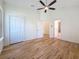 Bedroom with hardwood flooring, a ceiling fan, and direct access to the bathroom at 404 Hillsborough St, Palm Harbor, FL 34683