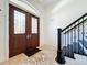 Grand foyer featuring ornate double doors, tiled flooring, and staircase with rod iron banister at 404 Hillsborough St, Palm Harbor, FL 34683