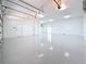 Bright three car garage with painted walls and floors and multiple entrance doors at 404 Hillsborough St, Palm Harbor, FL 34683