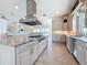 Spacious kitchen boasts stainless steel appliances, large island with cooktop, and an open floor plan at 404 Hillsborough St, Palm Harbor, FL 34683
