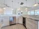 Open-concept kitchen includes stainless steel appliances, granite counters, a beverage cooler, and plenty of storage at 404 Hillsborough St, Palm Harbor, FL 34683