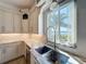 Bright kitchen with stainless steel sink, granite counters, and a view of the water through a sunny window at 404 Hillsborough St, Palm Harbor, FL 34683