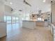 Open concept kitchen with stainless steel appliances, island cooktop, and water view at 404 Hillsborough St, Palm Harbor, FL 34683
