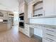 Kitchen with custom desk, marble countertops, stainless steel appliances and tile floors at 404 Hillsborough St, Palm Harbor, FL 34683