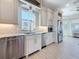 Modern kitchen showcases stainless steel appliances, granite counters, tile backsplash, and wood-look tile flooring at 404 Hillsborough St, Palm Harbor, FL 34683