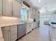 Modern kitchen with stainless steel appliances, granite countertops, backsplash, and wood-look tile flooring at 404 Hillsborough St, Palm Harbor, FL 34683